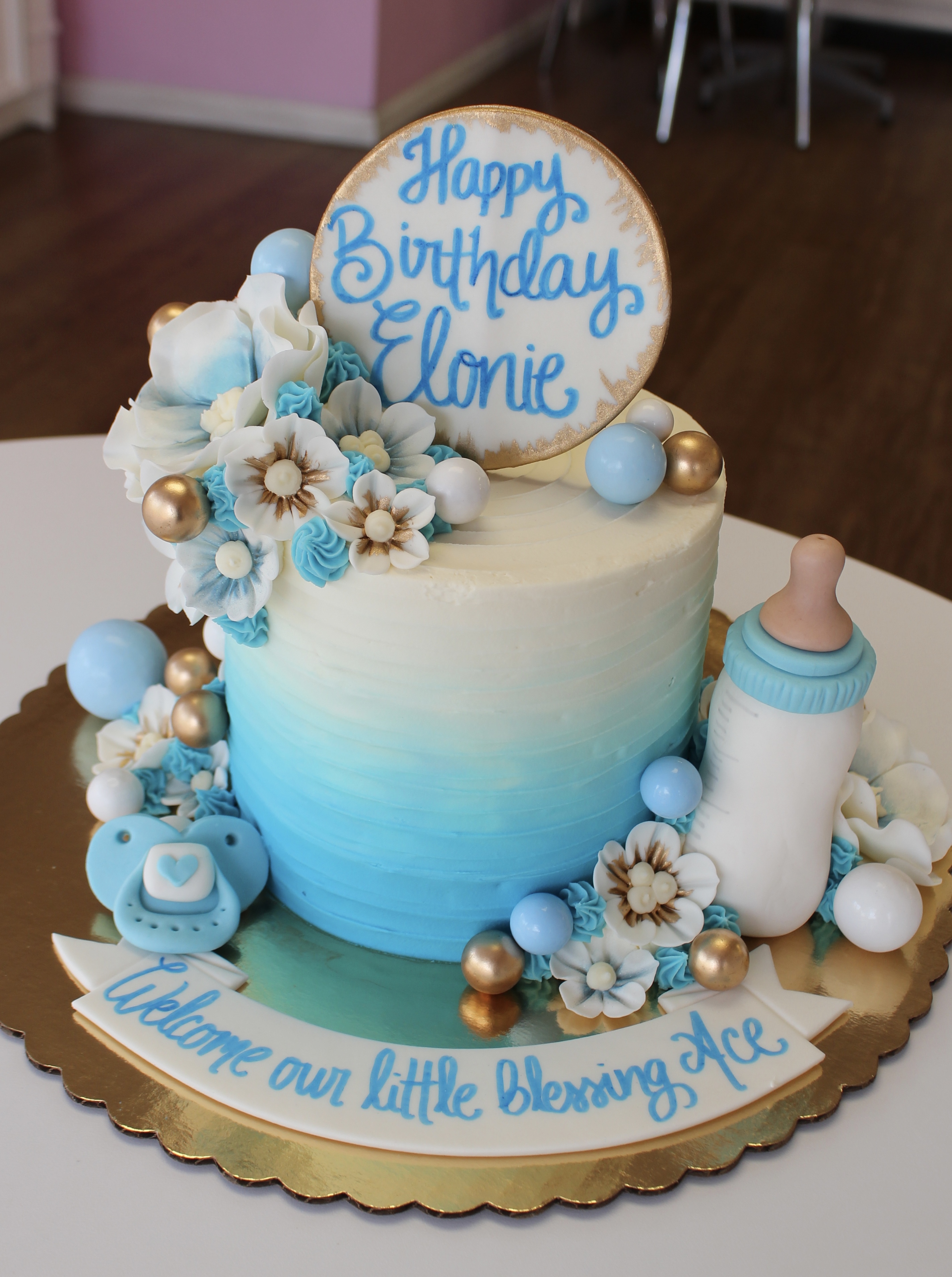 Baby Blue and White Ombre Kids Birthday Cake with Fondant Flowers, Pacifier, and Baby Bottle