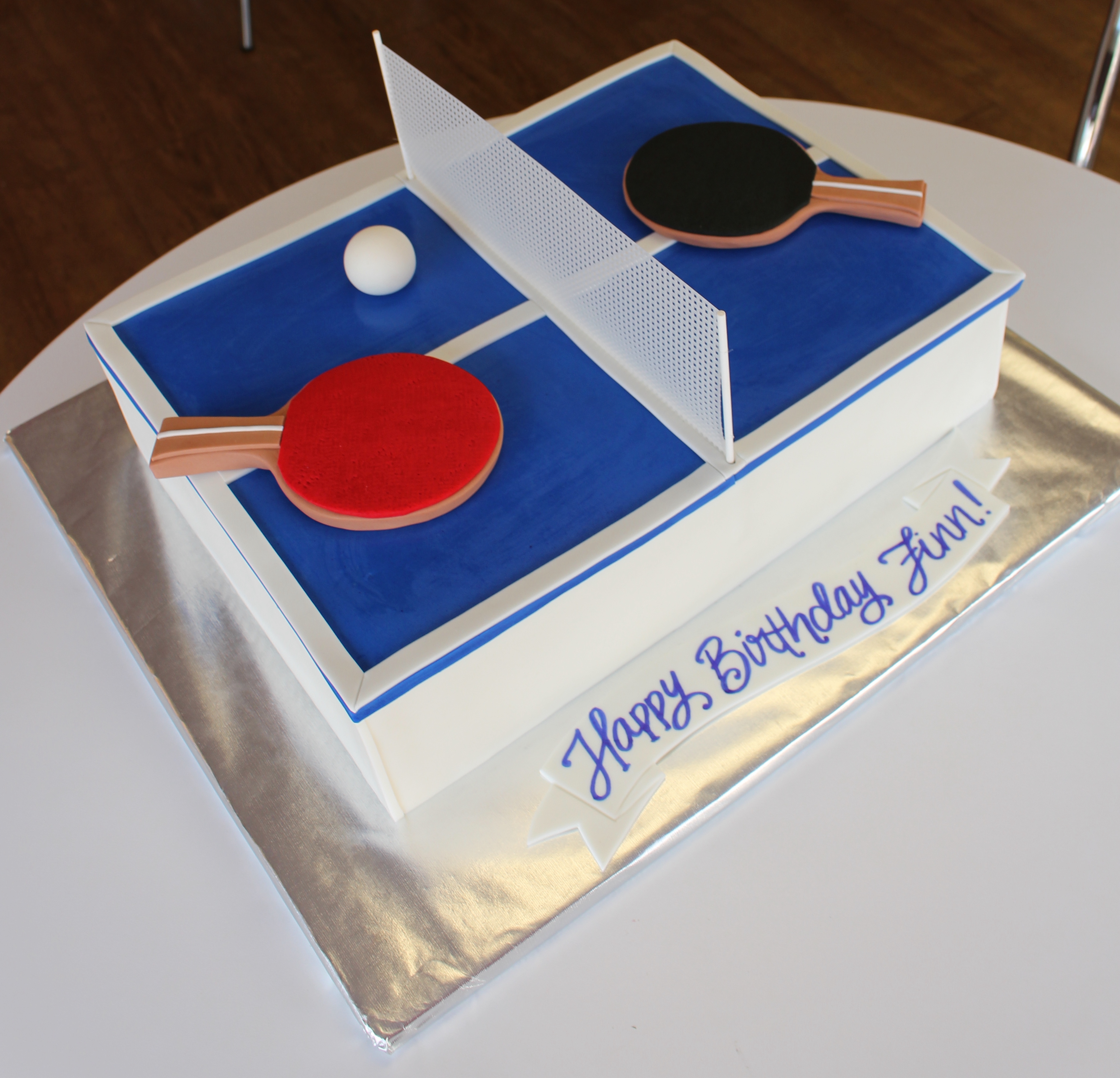 Blue Table Tennis Table Shaped Cake with Fondant Red and Black Paddles and Ball