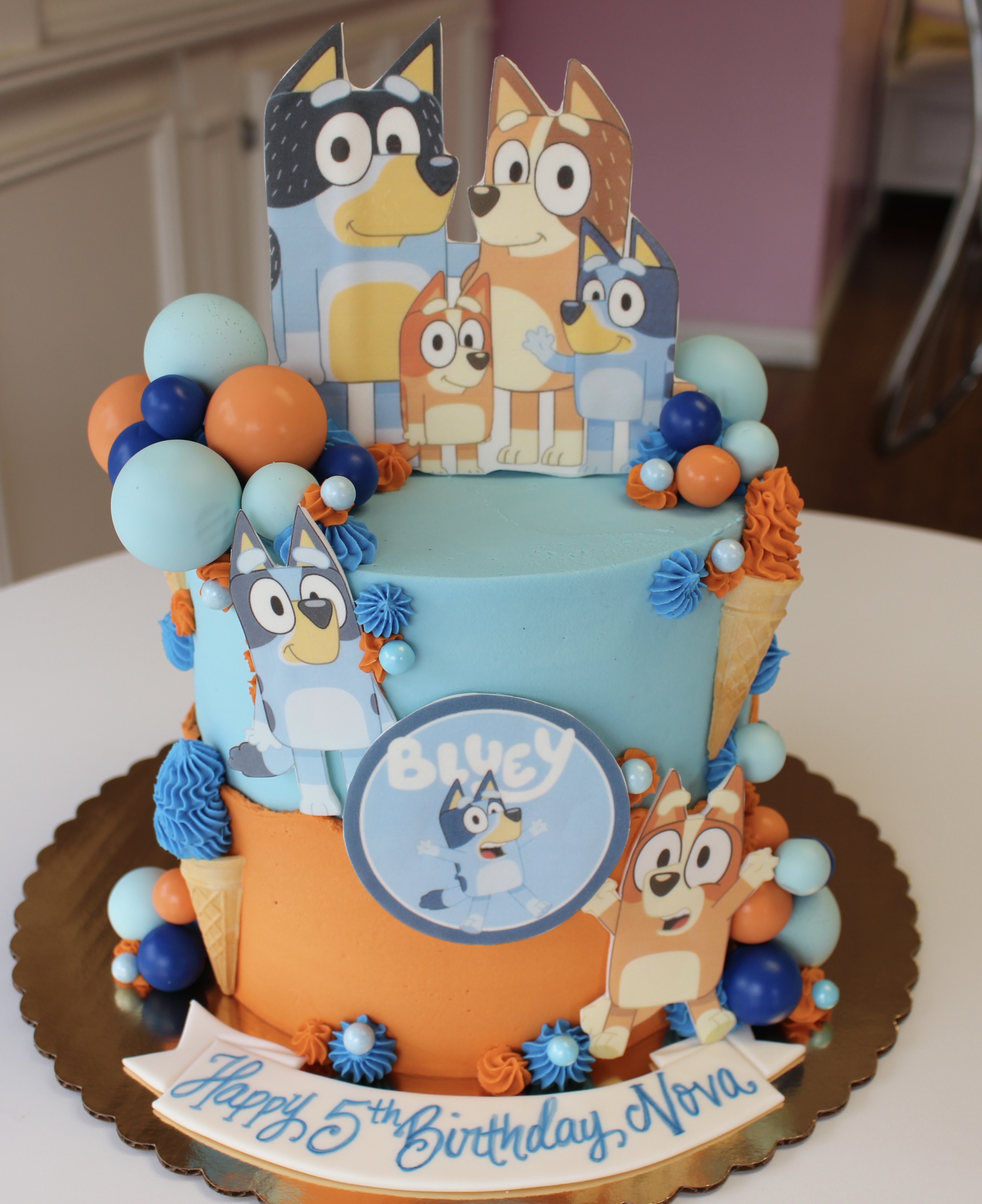 Blue and Orange Bluey and Bingo Themed Kids Birthday Cake with Balloons and Ice Ceam Cones