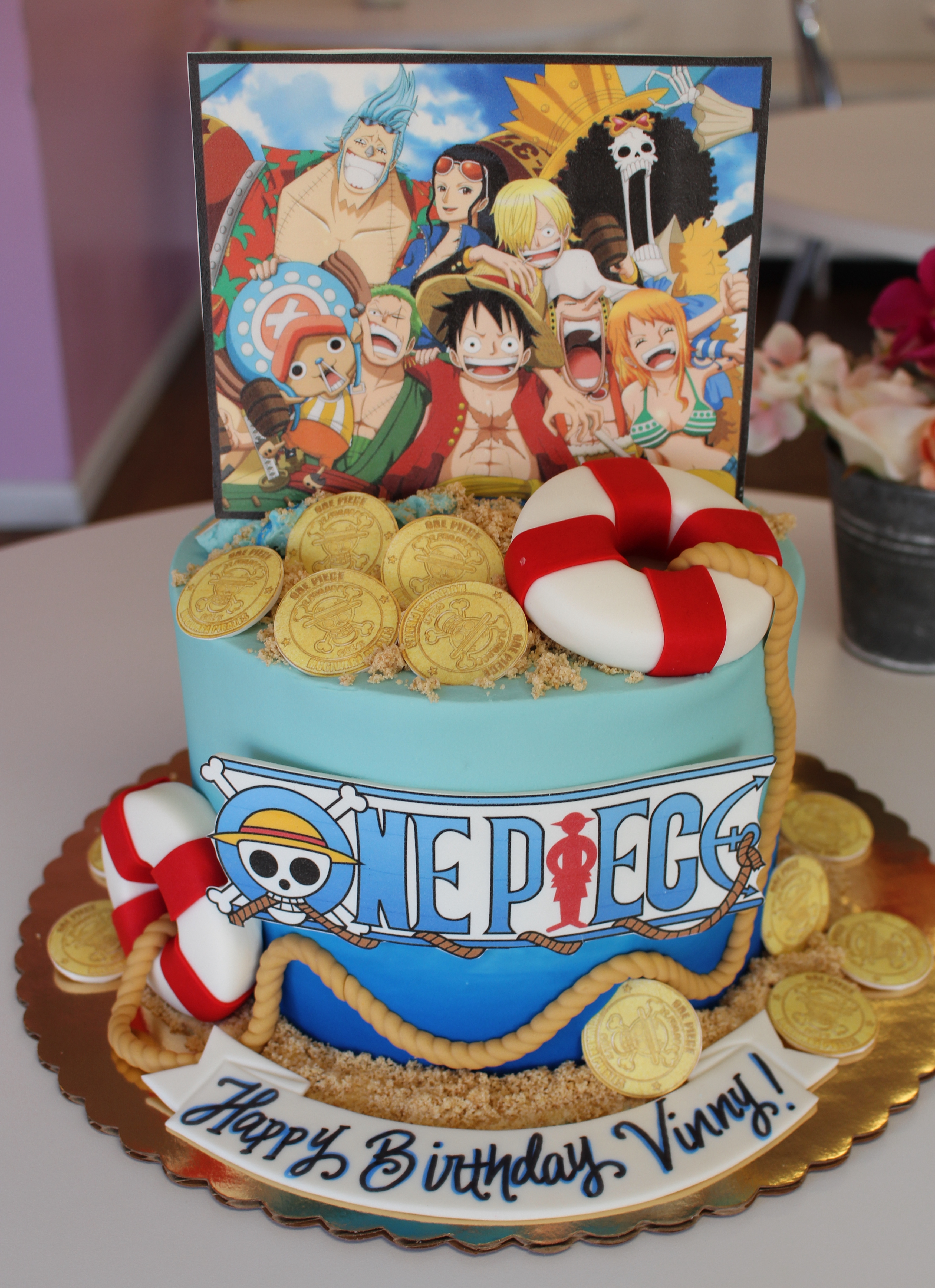 One Piece Themed Blue Ombre Birthday Cake with Fondant Live Preserver and Gold Coins