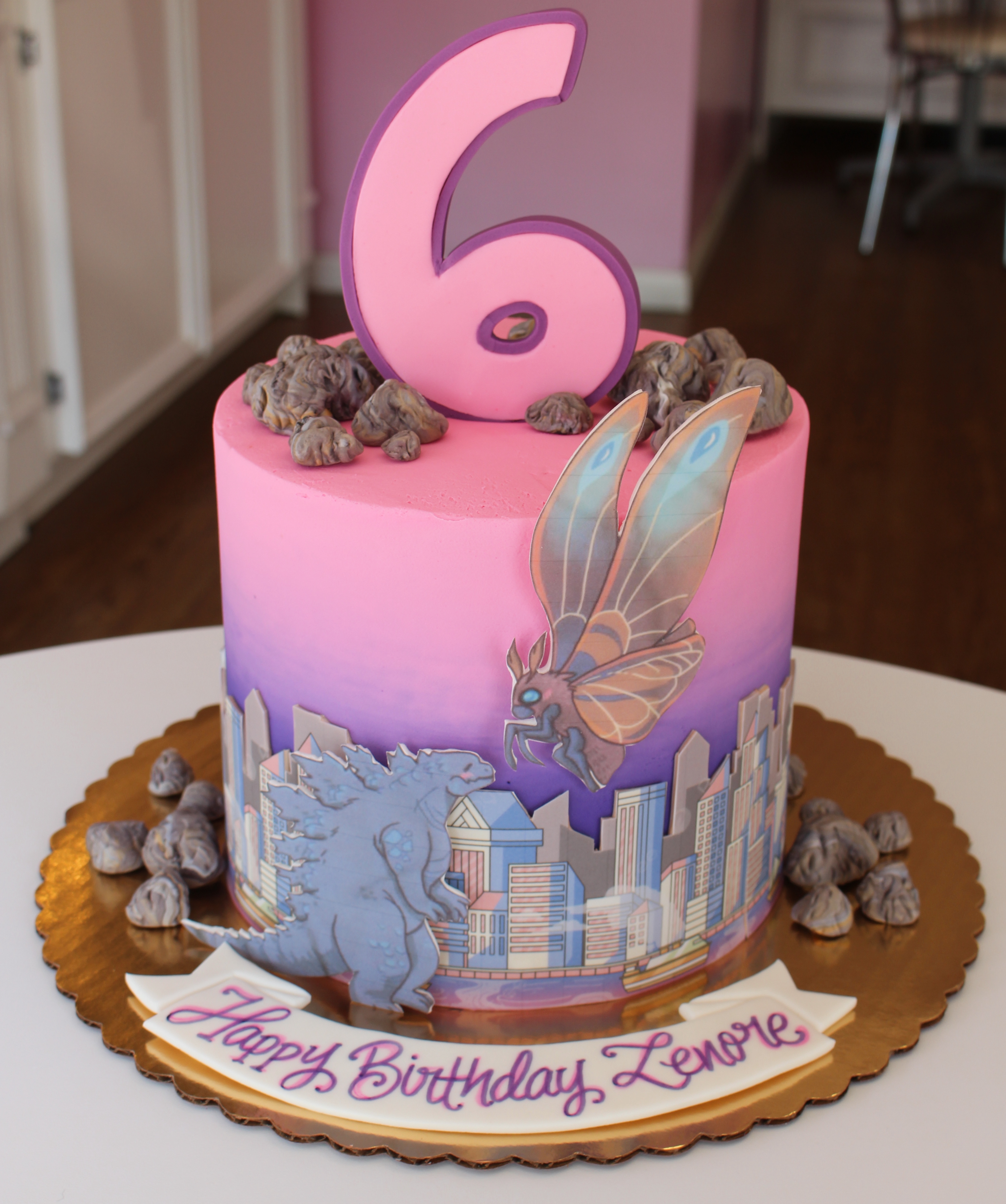 Pink and Purple Ombre Godzilla and Mothra Themed Cake with Fondant Topper and Rocks