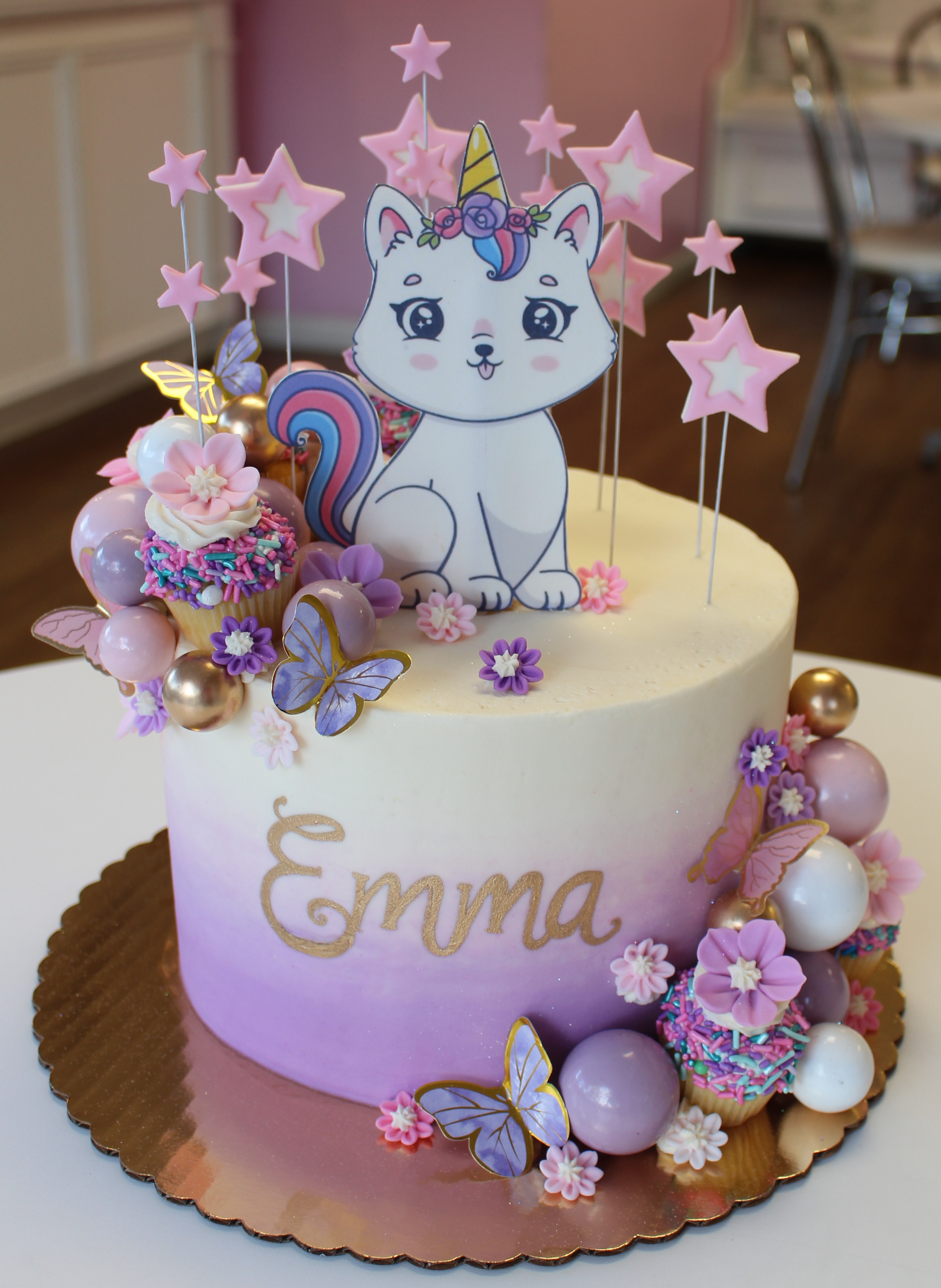 Purple Ombre Kids Birthday Cake with Unicorn Cat Butterflfies Stars and Mini Cupcakes