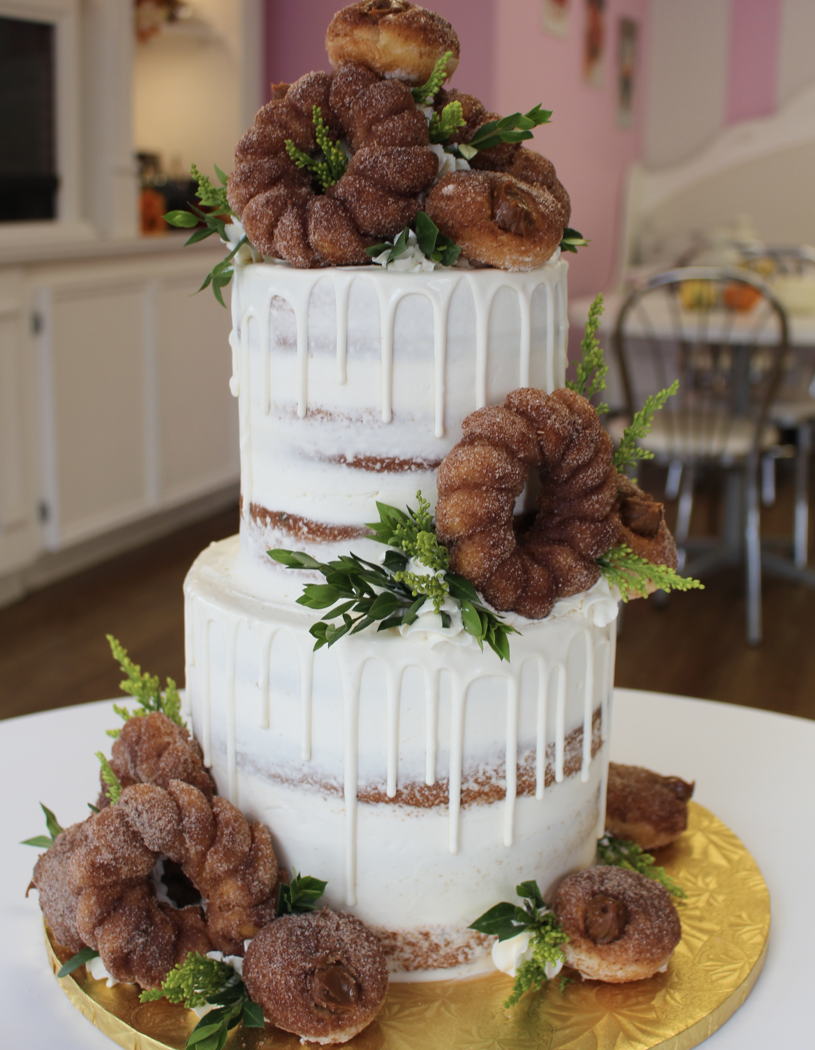 Rustic Naked Drip Cake with Churro Donuts Beignets and Greenery