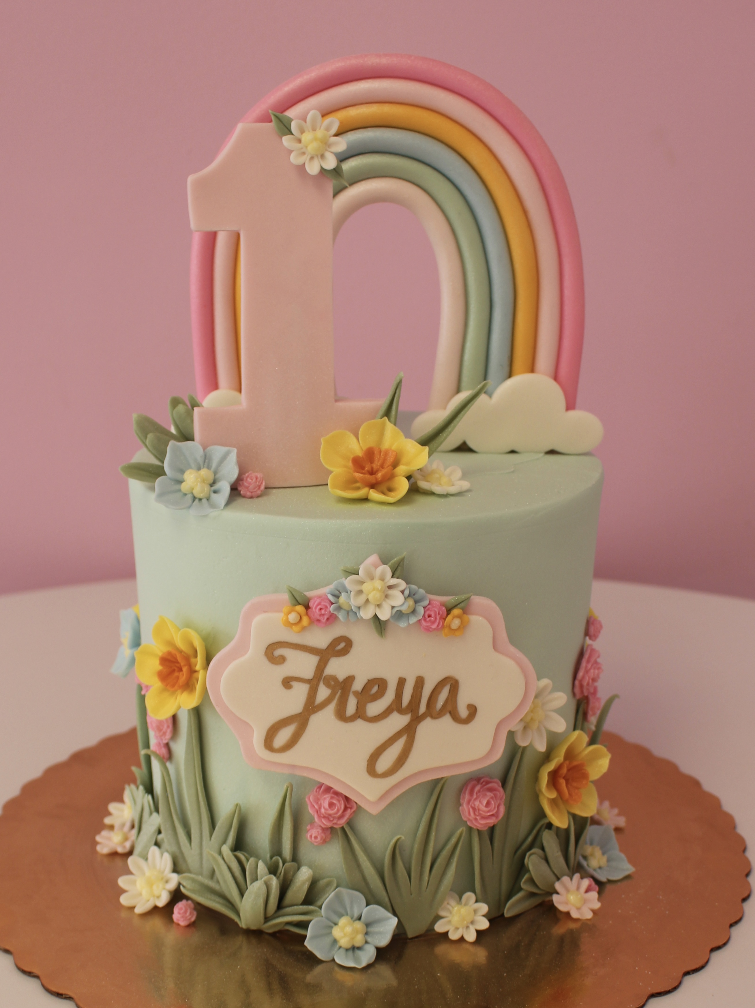 Sage Green Girls First Birthday Cake with Fondant Pastel Rainbow Flowers Clouds and Decorative Plaque