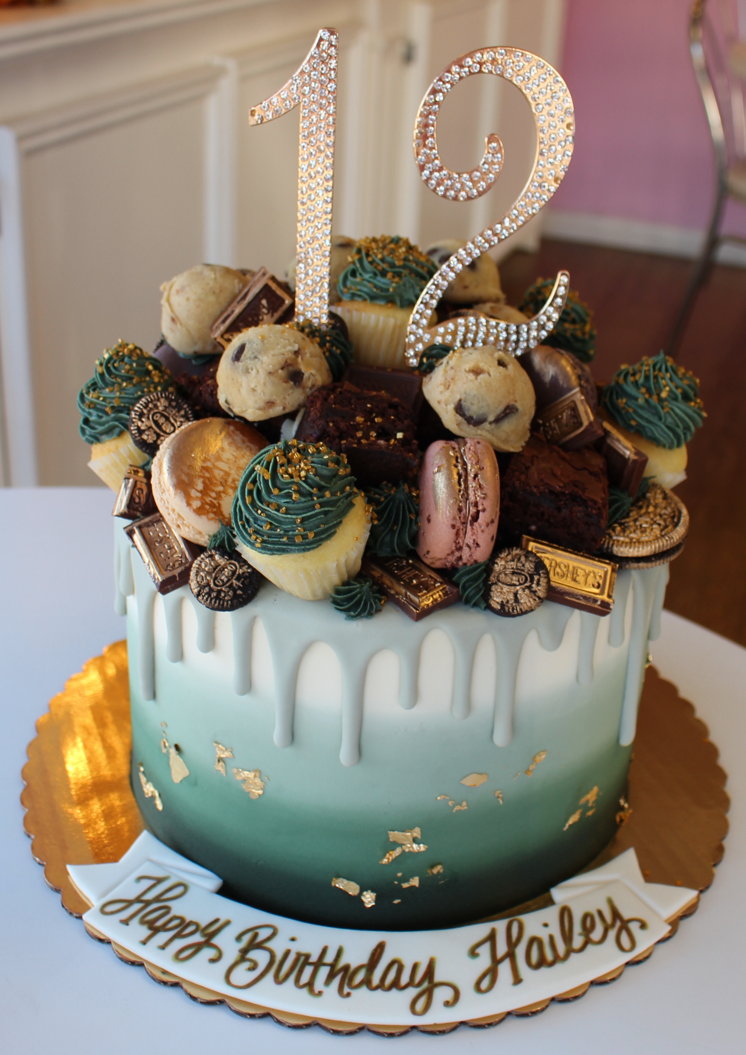 Sage Green Ombre Drip Cake with Brownies Mini Cupcakes Macarons and Cookie Dough Scoops