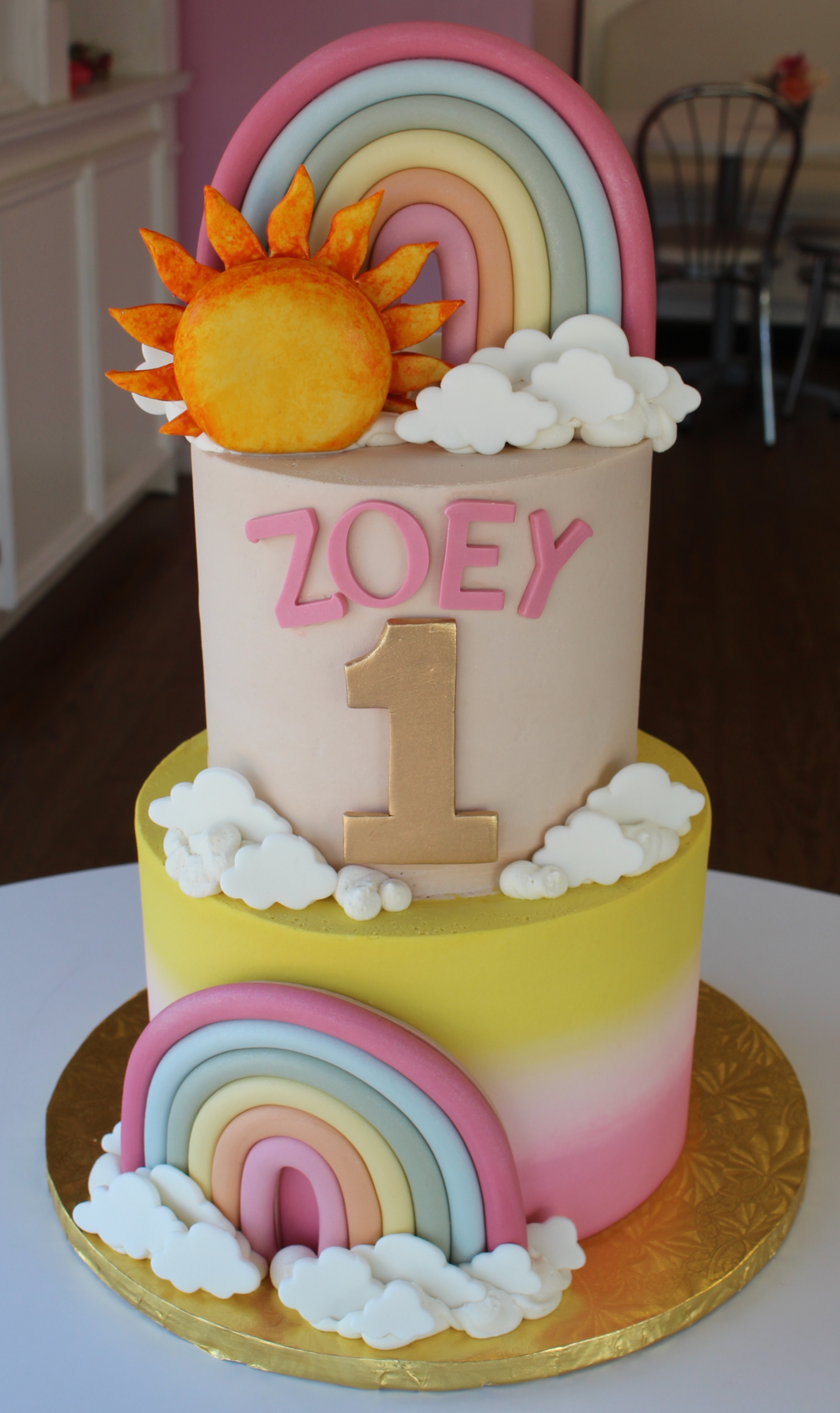 Two Tier Beige Yellow and Pink Ombre First Birthday Cake with Fondant Sun, Clouds, and Rainbows
