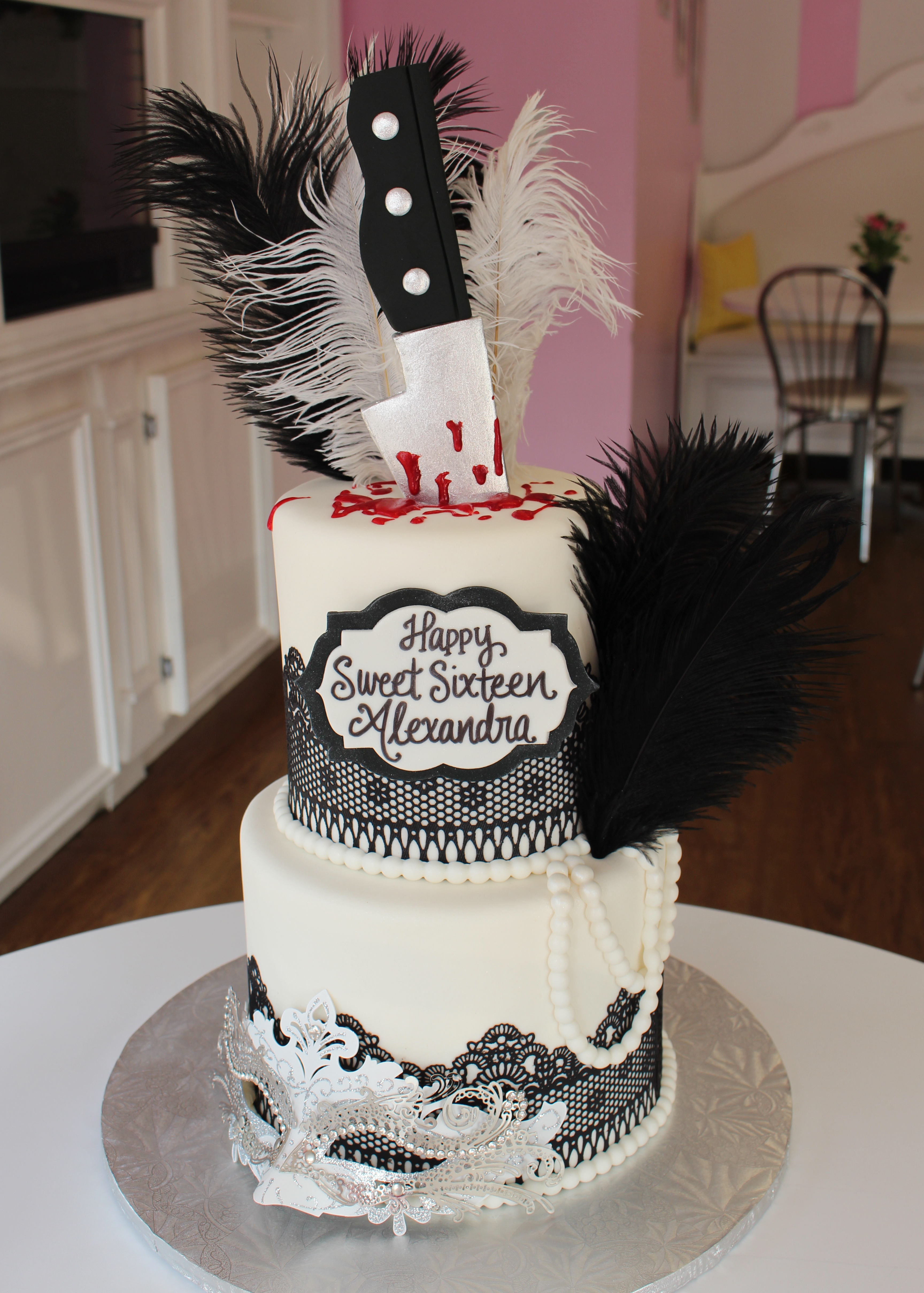 Two Tier Black and White Murder Mystery Masquerade Cake with Lace Border and Fondant Knife and Real Feathers