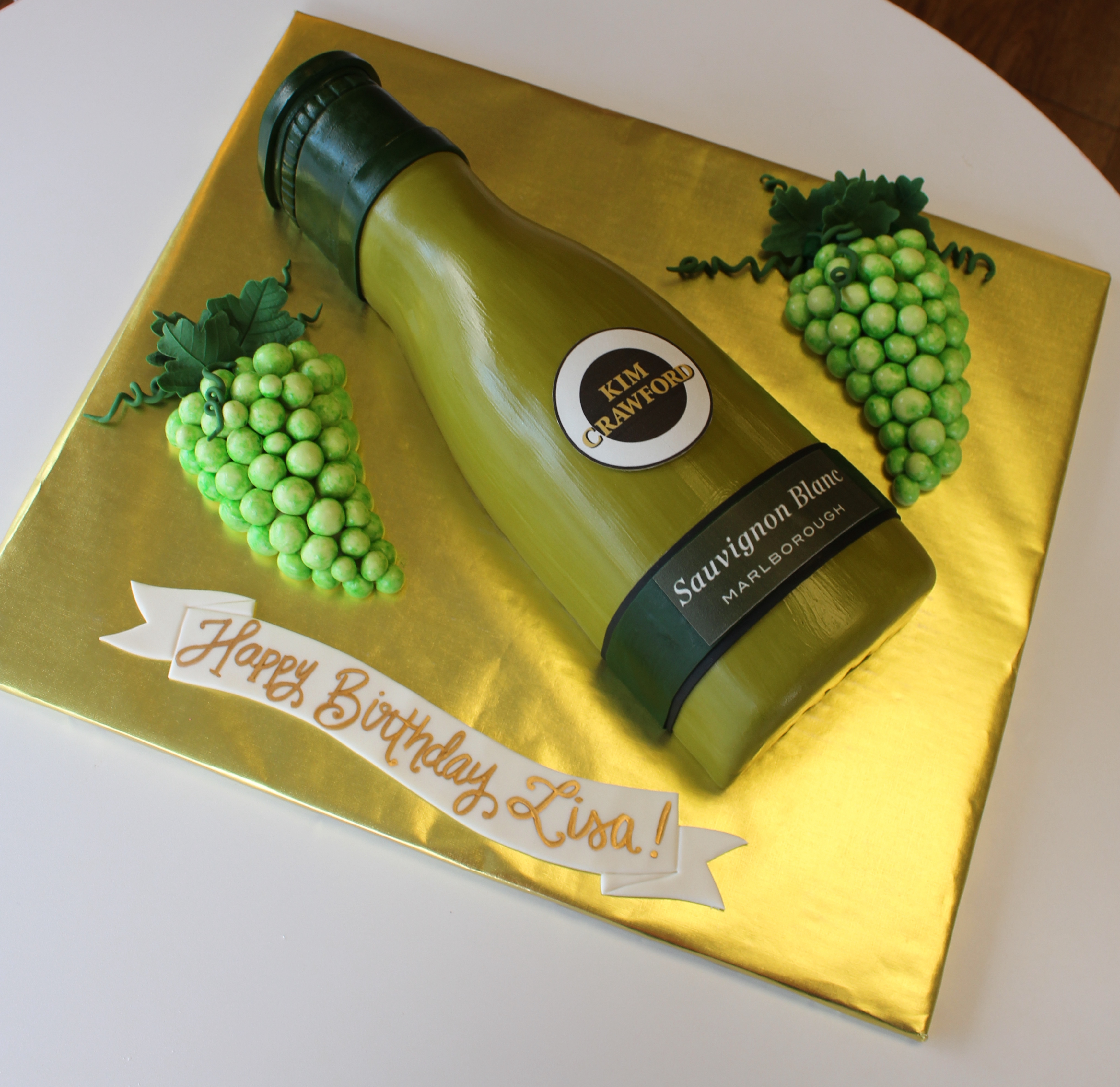 White Wine Bottle Shaped Cake with Green Fondant Grapes