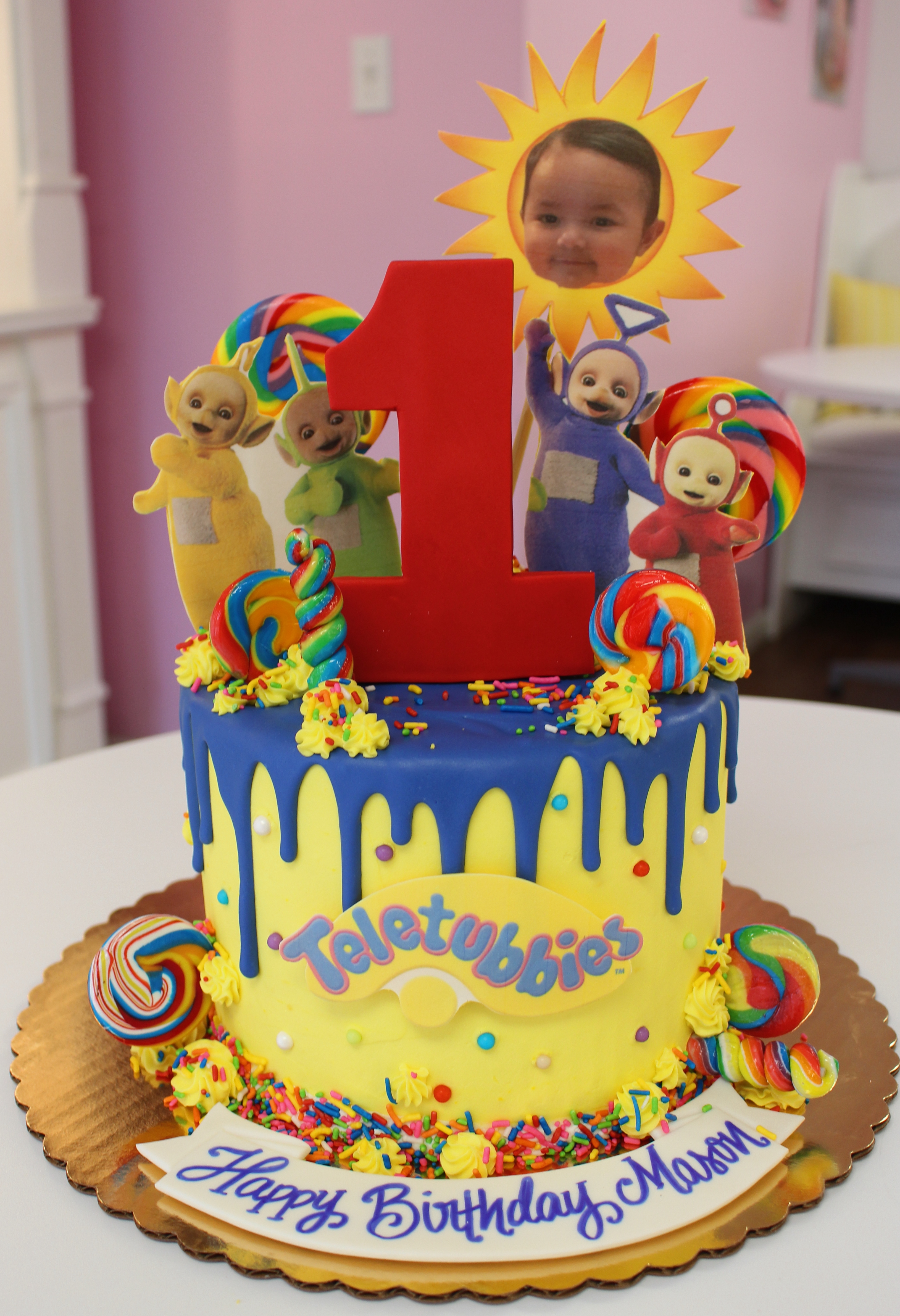 Yellow and Navy Blue Drip Teletubbies Themed Cake with Real Candy Lollipos